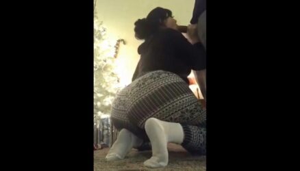 Brunette of Mega Ass sucks on the Christmas tree